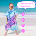 Childrens hooded poncho towel with mermaid scale pattern on beach, UV protection and non-shedding features shown